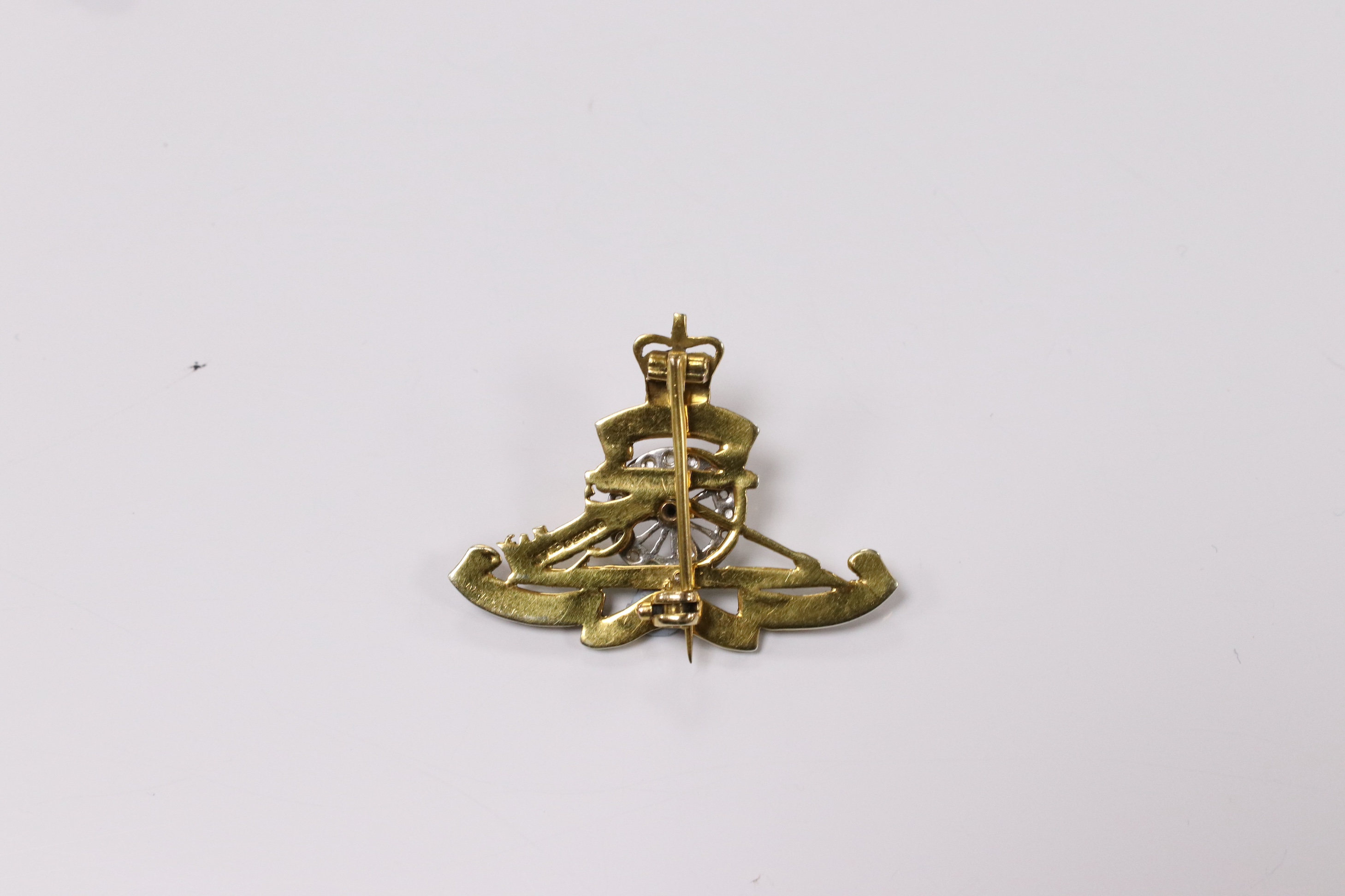 A mid 20th century 9ct gold, diamond and two colour enamel set Royal Artillery sweethearts brooch, 36mm, gross weight 5.7 grams. Condition - poor to fair